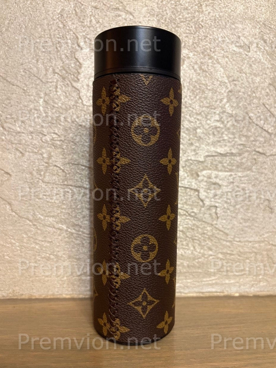 Monogram Louis Vuitton–style leather vacuum flask with stainless steel interior and LED touch display, presented as a premium fashion accessory.