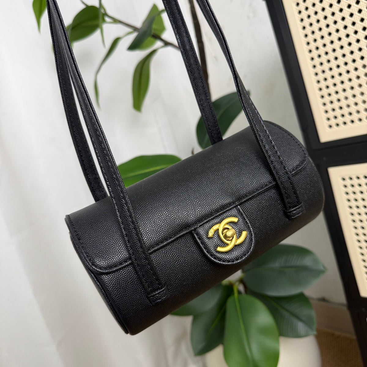 Black caviar leather mini bowling bag with gold hardware, front view