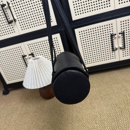 Black and gold vintage-style mini bowling bag on display