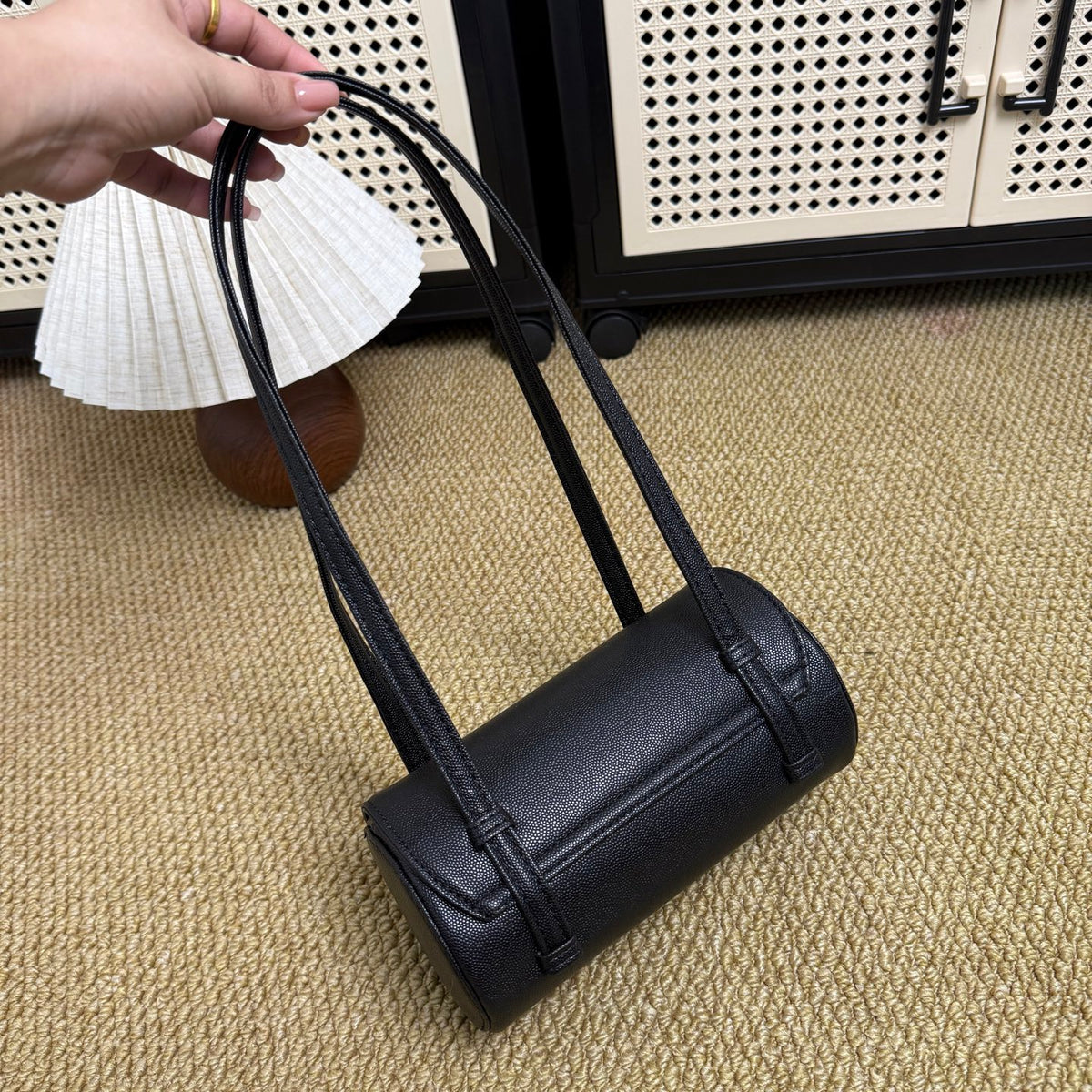 Classic black and gold barrel bag, detail of structured silhouette