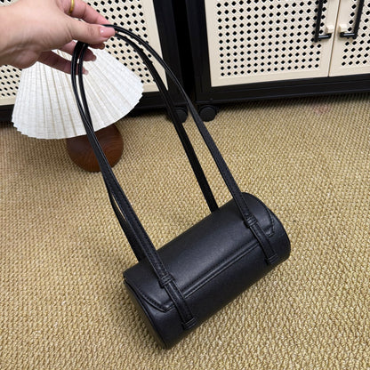 Classic black and gold barrel bag, detail of structured silhouette