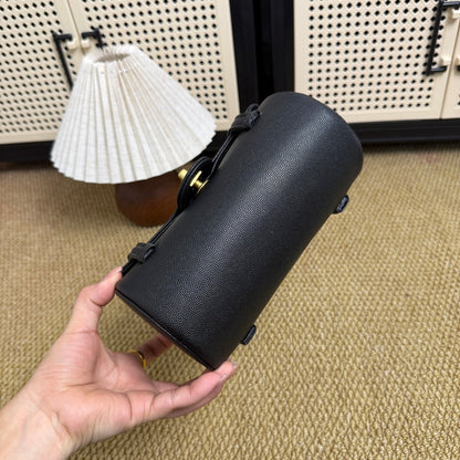Mini cylindrical shoulder bag in black textured leather