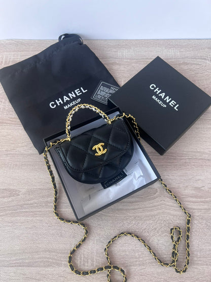 Black pearl chain mini bag with gold hardware and pearl-and-leather woven top handle, front view