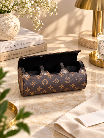 Close-up of monogram-pattern leather and clasp on vintage watch case