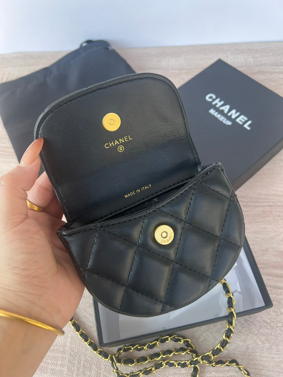 Pearl chain crossbody mini bag displayed at an angle
