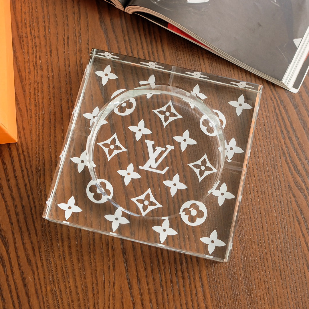 Crystal glass monogram ashtray angled view on wooden surface