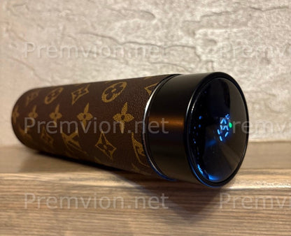 Designer-inspired stainless steel thermos featuring premium Louis Vuitton leather wrap and digital temperature display, shown with removable lid.