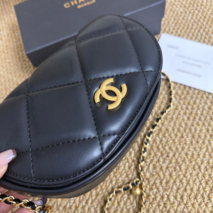 Black and gold quilted mini bag, angled view with chain strap