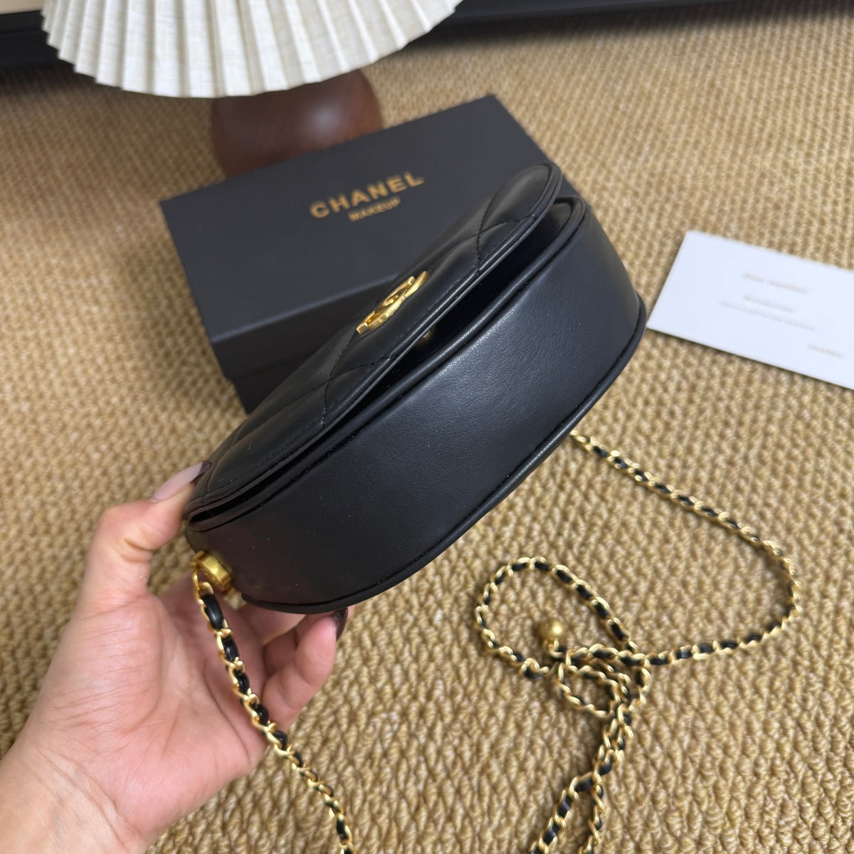 Black gold quilted chain bag, detail of strap and clasp