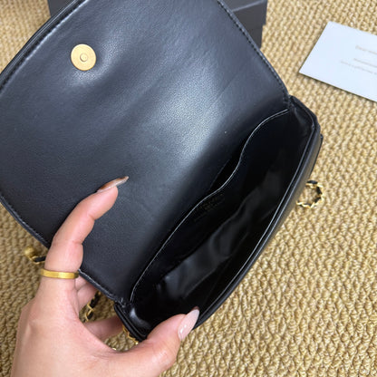 Black quilted mini chain shoulder bag worn crossbody, lifestyle view