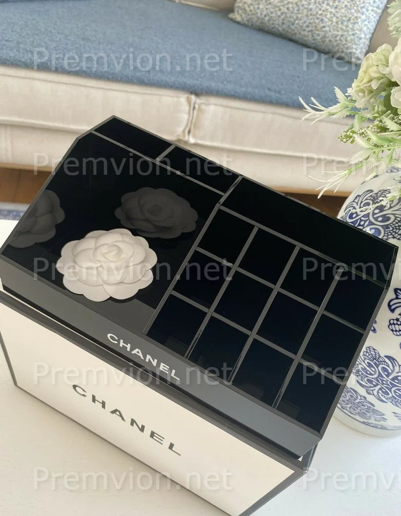 Luxury black Chanel acrylic cosmetic organizer with multiple compartments.