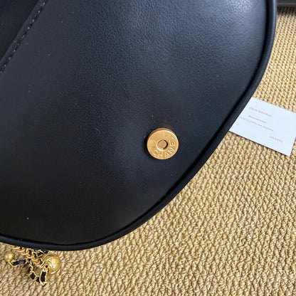 Elegant black gold quilted handbag, top view of quilted texture