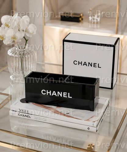 Luxury Chanel acrylic makeup organizer displayed on a vanity for storing brushes, lipsticks, and cosmetics.