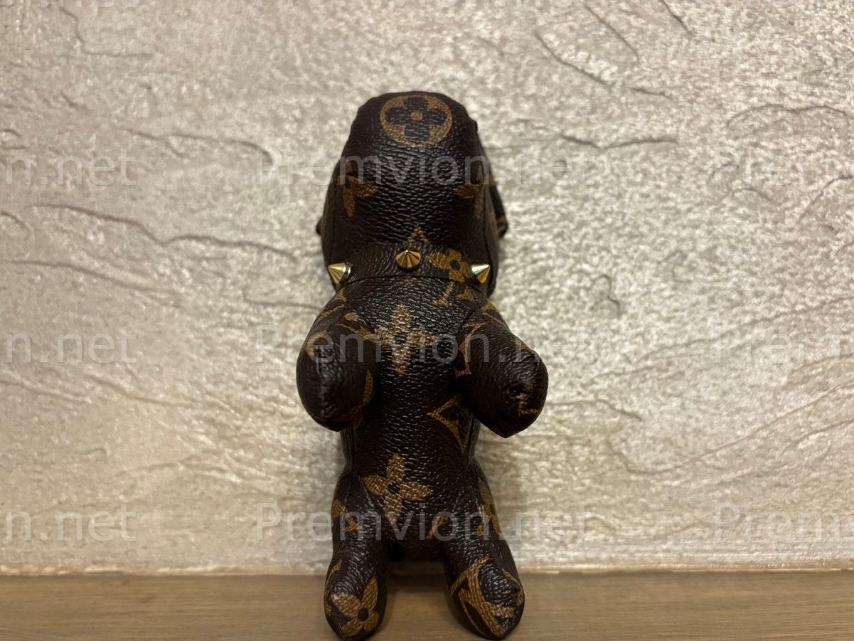 Close-up of artisan French Bulldog bag charm made from upcycled monogram leather, showcasing detailed stitching and luxury sustainable craftsmanship