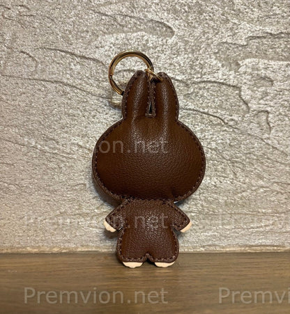Luxury LV-inspired Labubu bunny bag charm made from premium monogram leather, designed as a collectible fashion accessory for handbags and keys.