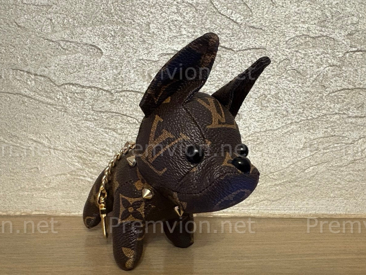 Designer-style French Bulldog leather keychain with polished gold hardware, handcrafted from repurposed luxury materials, trendy eco-conscious fashion accessory