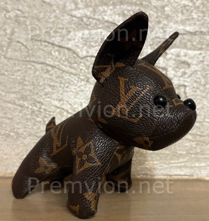 Side profile of French Bulldog sculpture crafted from reclaimed Louis Vuitton leather.