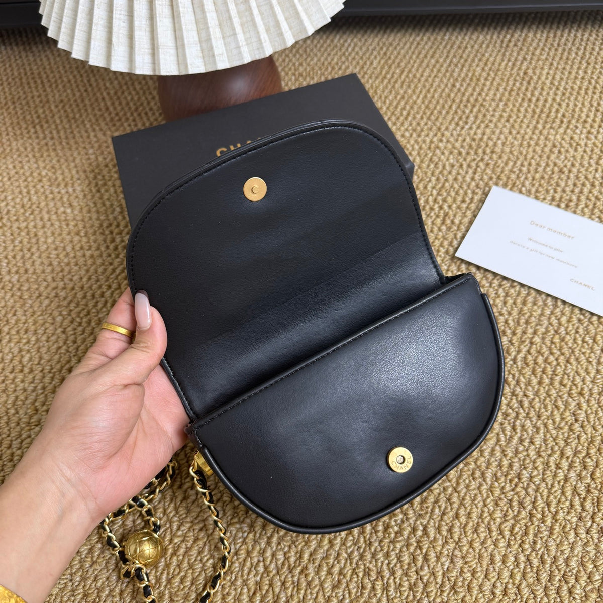 Vintage-style black quilted mini bag with gold hardware, front view